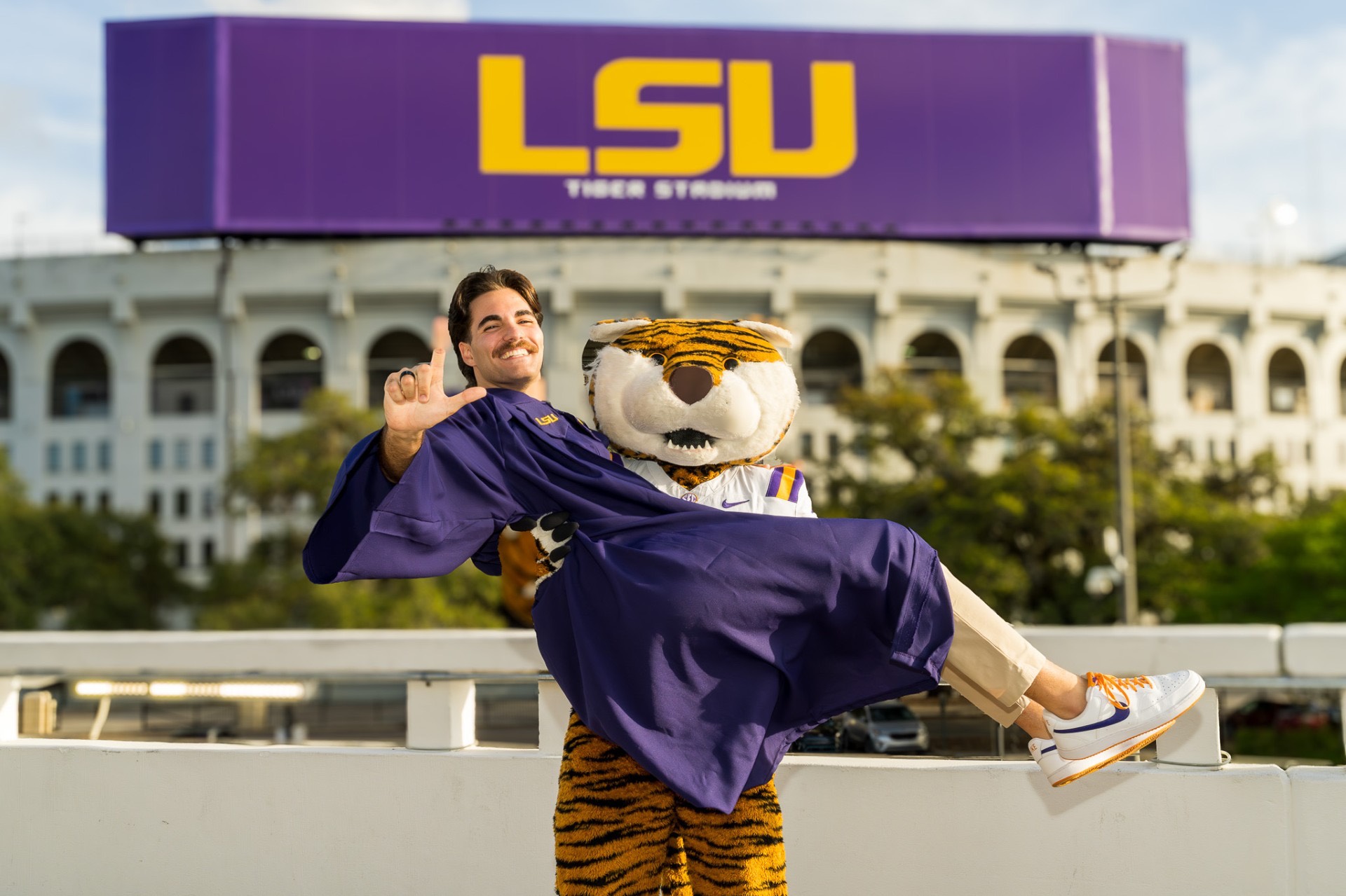 Landon Terro poses with Mike the Tiger in front of Tiger Stadium