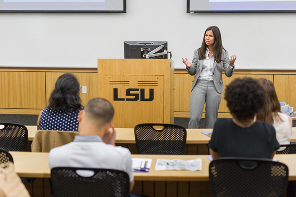 Suzy Caleo lectures at front of classroom