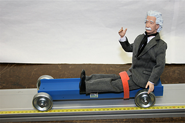 photo: Einstein action figure riding on cart with/without seatbelt - hits wall