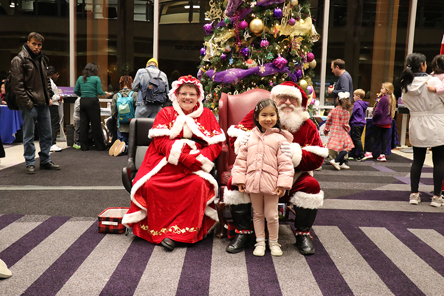 child with Santa and Mrs. Claus
